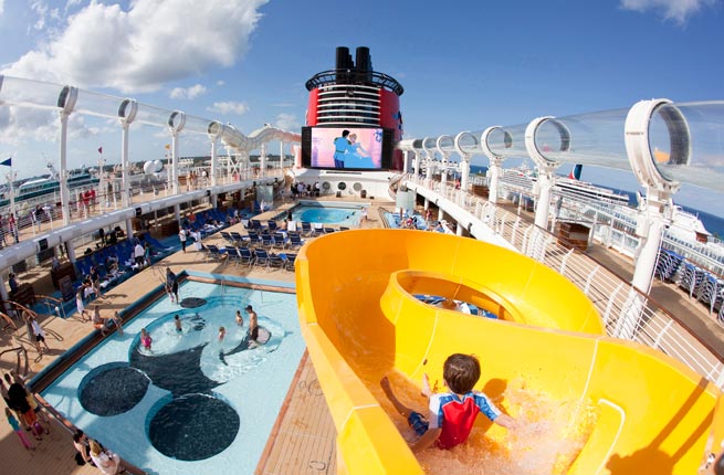 Mickey’s Pool, a favorite feature of the Disney Cruise Line fleet, continues on the Disney Dream. This play area for children features a Mickey Mouse-shaped pool and an oversized version of Mickey’s hand supporting a yellow winding slide that splashes down into the pool area. (Jimmy DeFlippo, photographer); MICKEY'S POOL ON THE DISNEY DREAM